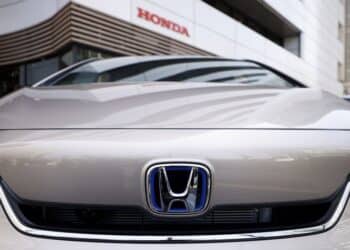 The Honda Motor Co. badge on a Fit e:HEV vehicle displayed outside a showroom at the company's headquarters in Tokyo, Japan.