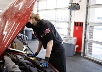 An employee works under the hood of a vehicle at a Valvoline Inc. Instant Oil Change location in Indianapolis, Indiana, U.S., on Wednesday, Feb. 2, 2022. Valvoline Inc. is expected to release earnings figures on February 8.