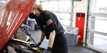 An employee works under the hood of a vehicle at a Valvoline Inc. Instant Oil Change location in Indianapolis, Indiana, U.S., on Wednesday, Feb. 2, 2022. Valvoline Inc. is expected to release earnings figures on February 8.