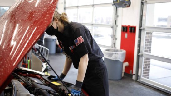 An employee works under the hood of a vehicle at a Valvoline Inc. Instant Oil Change location in Indianapolis, Indiana, U.S., on Wednesday, Feb. 2, 2022. Valvoline Inc. is expected to release earnings figures on February 8.