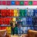 Shoppers browse colorful shirts at a clothing store