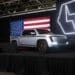 An image of Lordstown Motor's Endurance pickup truck on a stage with an American flag behind it.