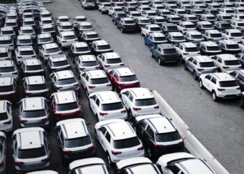 A parking lot with many new cars