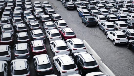 A parking lot with many new cars
