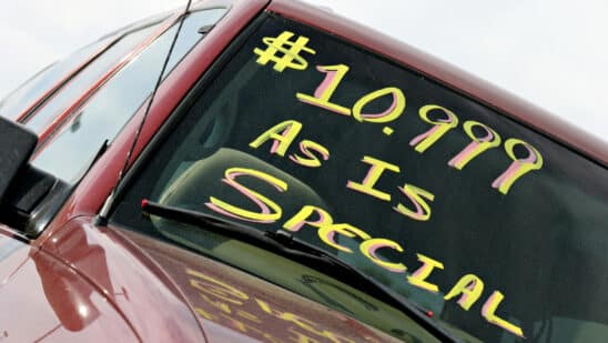 Used car with $10,000 as is special written on windshield