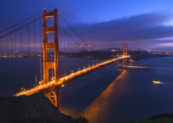 Golden gate bridge at night with boats san francisco california