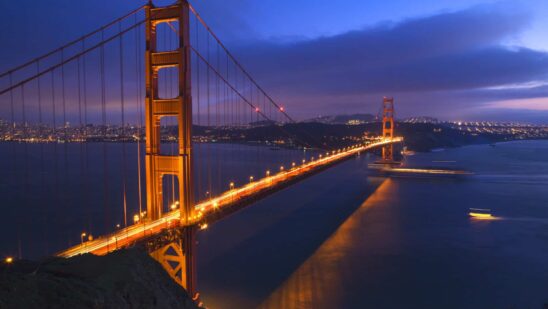 Golden gate bridge at night with boats san francisco california