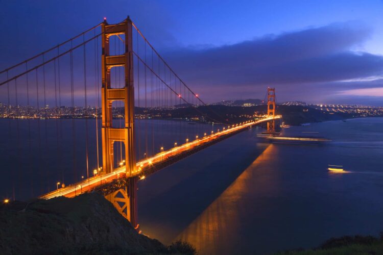 Golden gate bridge at night with boats san francisco california