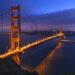 Golden gate bridge at night with boats san francisco california