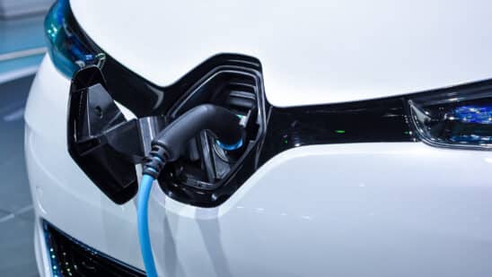 The electric vehicle charging cable inserted in plug