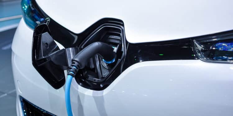 The electric vehicle charging cable inserted in plug