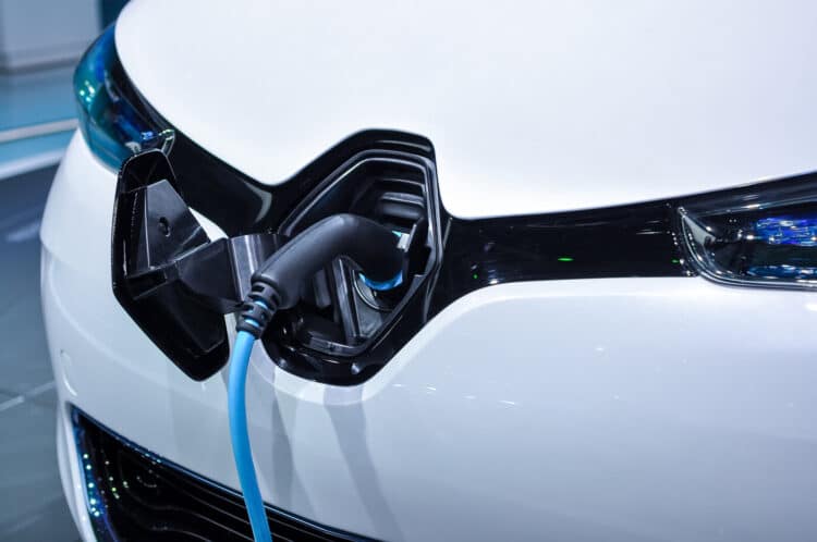 The electric vehicle charging cable inserted in plug