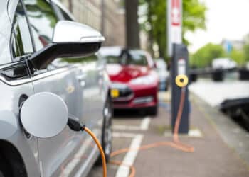 Silver electric vehicle at a charging station