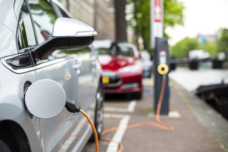 Silver electric vehicle at a charging station
