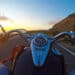 Biker riding a classic motorcycle at sunset