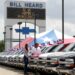 Two people looking at a car in a sales lot in Texas