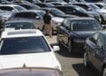 A car dealer walks past cars for sale at a used car dealership in Jersey City, New Jersey, U.S, on Wednesday, May 20, 2020. Governor Phil Murphy has lifted restrictions on in-person auto sales, provided the businesses follow social distancing guidelines, NBC reported.