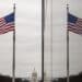 The American flag reflected on building walls in front of the U.S. Capitol building. Photographer: Samuel Corum/Bloomberg