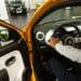 An employee in the driver's seat of a Renault Twingo E-Tech electric automobile at a Renault SA showroom