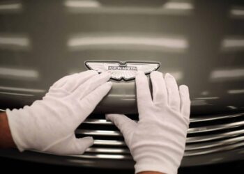 GAYDON, ENGLAND - JANUARY 10: An Aston Martin Vanquish is inspected by hand inside a light booth at the company headquarters and production plant on January 10, 2013 in Gaydon, England. The iconic British brand is celebrating its 100th anniversary. Lionel Martin and Robert Bamford created Bamford & Martin on January 15 1913, which later became Aston Martin in honour of Bamfords wins at the Aston Clinton Hillclimb in Buckinghamshire.