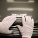 GAYDON, ENGLAND - JANUARY 10: An Aston Martin Vanquish is inspected by hand inside a light booth at the company headquarters and production plant on January 10, 2013 in Gaydon, England. The iconic British brand is celebrating its 100th anniversary. Lionel Martin and Robert Bamford created Bamford & Martin on January 15 1913, which later became Aston Martin in honour of Bamfords wins at the Aston Clinton Hillclimb in Buckinghamshire.