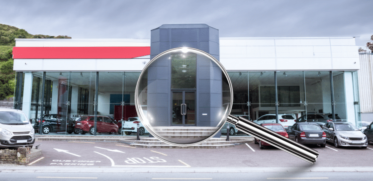 dealership with magnifying glass in front