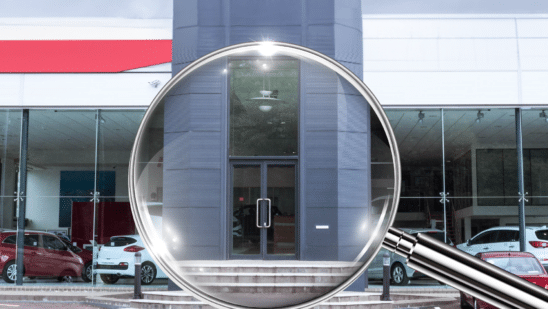 dealership with magnifying glass in front