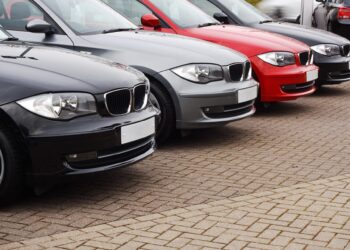 Row of prestige used cars for retail sale in a motor dealers yard