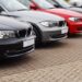 Row of prestige used cars for retail sale in a motor dealers yard