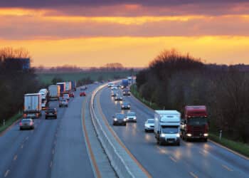 Cars driving on the highway at sunset