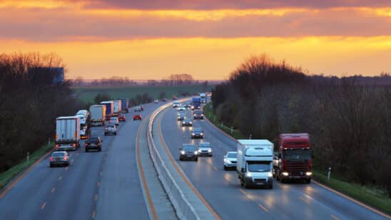 Cars driving on the highway at sunset