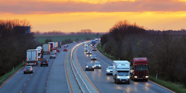 Cars driving on the highway at sunset