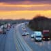 Cars driving on the highway at sunset