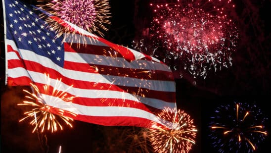 Fireworks going off behind an American flag
