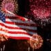 Fireworks going off behind an American flag