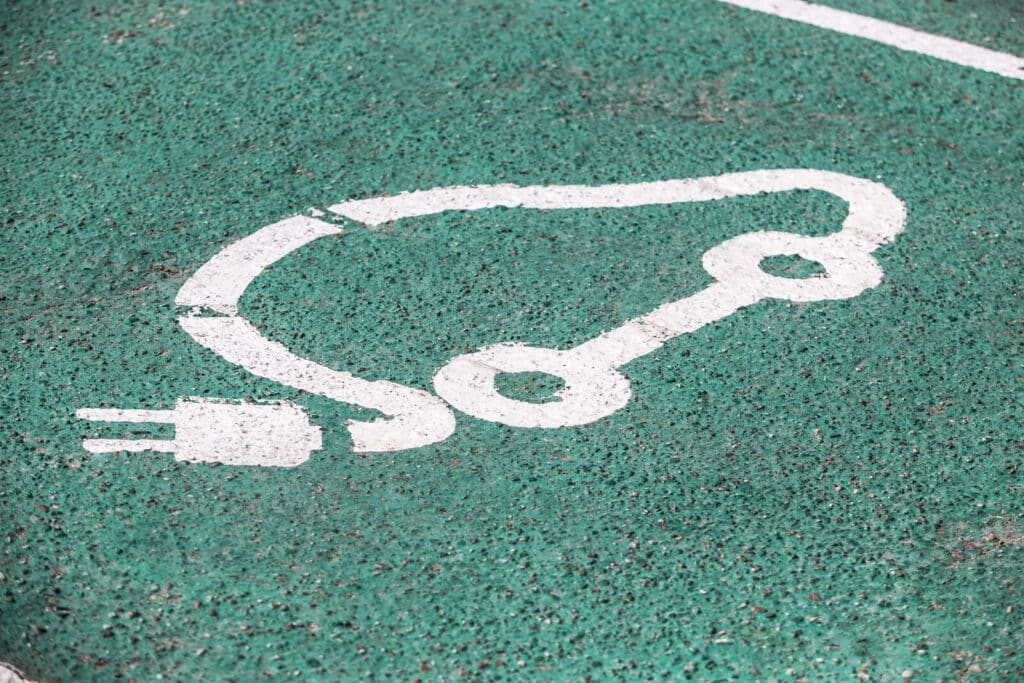 Electric vehicle charging sign on asphalt