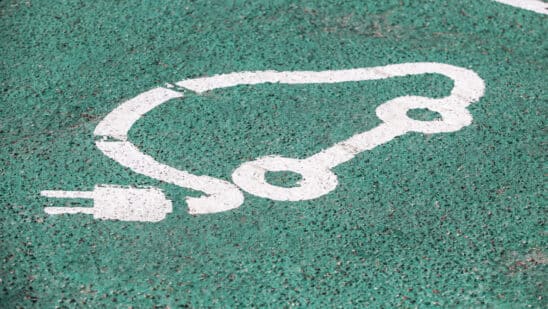 Electric vehicle charging sign on asphalt