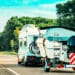 Rv camper car with motor boat on road. caravan and motorhome on trip