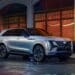 Front 7/8 view of Cadillac ESCALADE IQ Sport in Flare Metallic with shield-shaped grille in view.