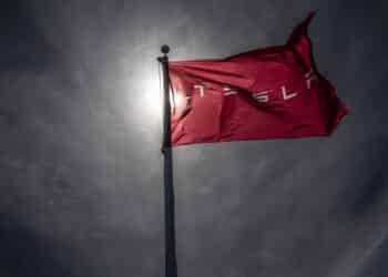 A Tesla branded flag outside a dealership in Corte Madera, California, US, on Thursday, March 2, 2023. Tesla Inc.'s much-awaited investor day failed to live up to the hype, and the shares of the electric vehicle maker are paying the price. Photographer: David Paul Morris/Bloomberg