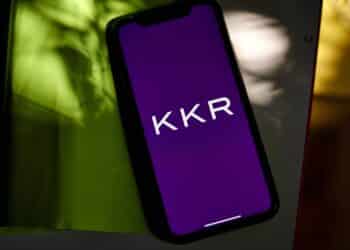 The KKR & Co. logo on a smartphone arranged in the Brooklyn borough of New York, US, on Wednesday, July 12, 2023. KKR & Co. is exploring options for its majority stake in a commercial lighting manufacturer in China including a potential sale, according to people familiar with the matter. Photographer: Gabby Jones/Bloomberg