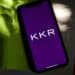 The KKR & Co. logo on a smartphone arranged in the Brooklyn borough of New York, US, on Wednesday, July 12, 2023. KKR & Co. is exploring options for its majority stake in a commercial lighting manufacturer in China including a potential sale, according to people familiar with the matter. Photographer: Gabby Jones/Bloomberg