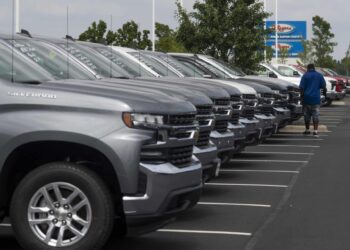 A customer looks over General Motors Co. Chevrolet vehicles displayed for sale at a car dealership in Grove City, Ohio, U.S., on Saturday, Aug. 15, 2020. Sport-utility vehicles and trucks are dominating U.S. auto sales like never before as carmakers start to recover from the biggest shock to their industry in decades.