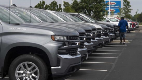 A customer looks over General Motors Co. Chevrolet vehicles displayed for sale at a car dealership in Grove City, Ohio, U.S., on Saturday, Aug. 15, 2020. Sport-utility vehicles and trucks are dominating U.S. auto sales like never before as carmakers start to recover from the biggest shock to their industry in decades.