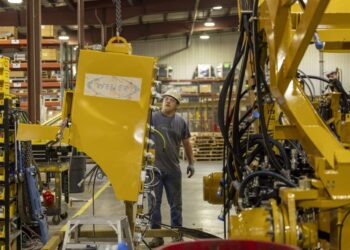 Kyle Kersbergen works on heavy machinery at Weiler, a manufacturing factory, in Knoxville, Iowa, US, on Thursday, July 21, 2023.