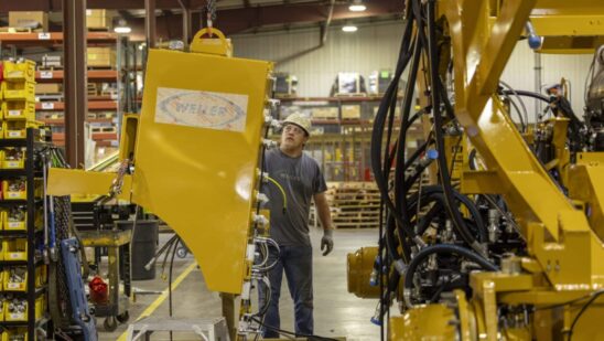 Kyle Kersbergen works on heavy machinery at Weiler, a manufacturing factory, in Knoxville, Iowa, US, on Thursday, July 21, 2023.
