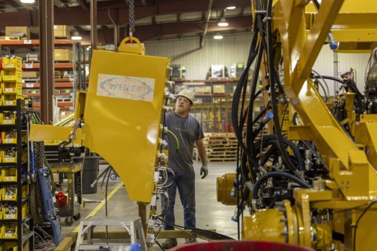 Kyle Kersbergen works on heavy machinery at Weiler, a manufacturing factory, in Knoxville, Iowa, US, on Thursday, July 21, 2023.