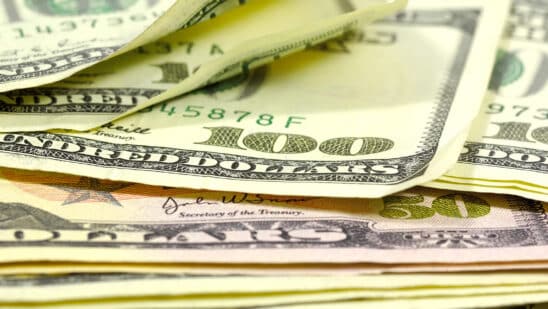 Photo of hundred dollar bills and fifty dollar bills stacked on each other