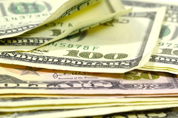 Photo of hundred dollar bills and fifty dollar bills stacked on each other