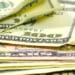 Photo of hundred dollar bills and fifty dollar bills stacked on each other
